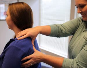 Dr. Adkins putting hand pressure on patient's shoulder
